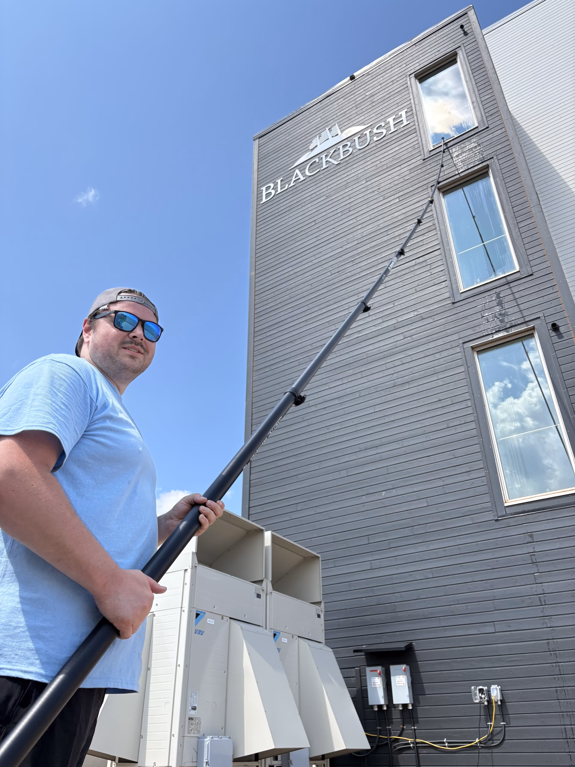 Washing windows with a water fed pole at Blackbush Beach Resort